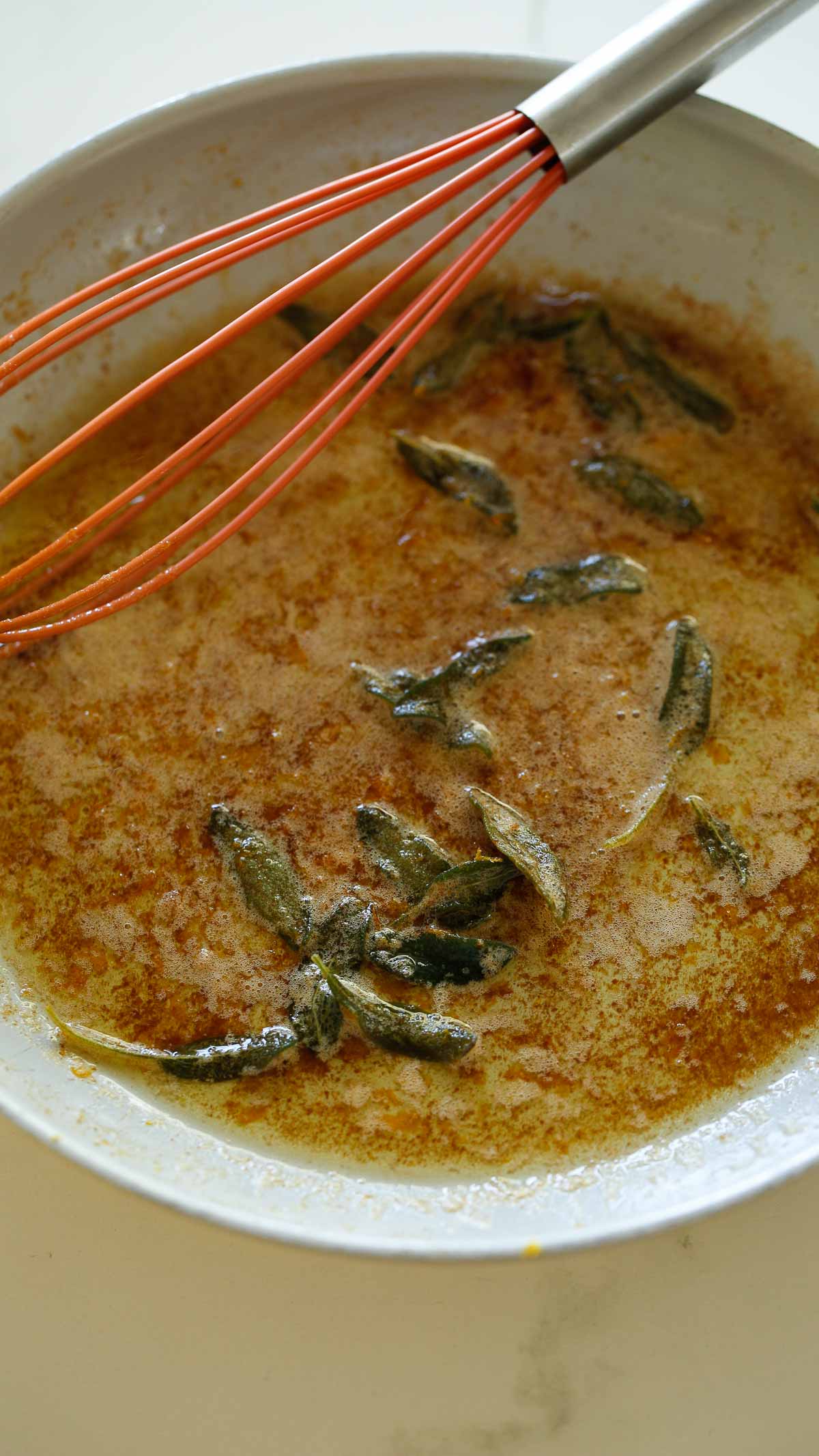 Browned butter in a pan with sage.