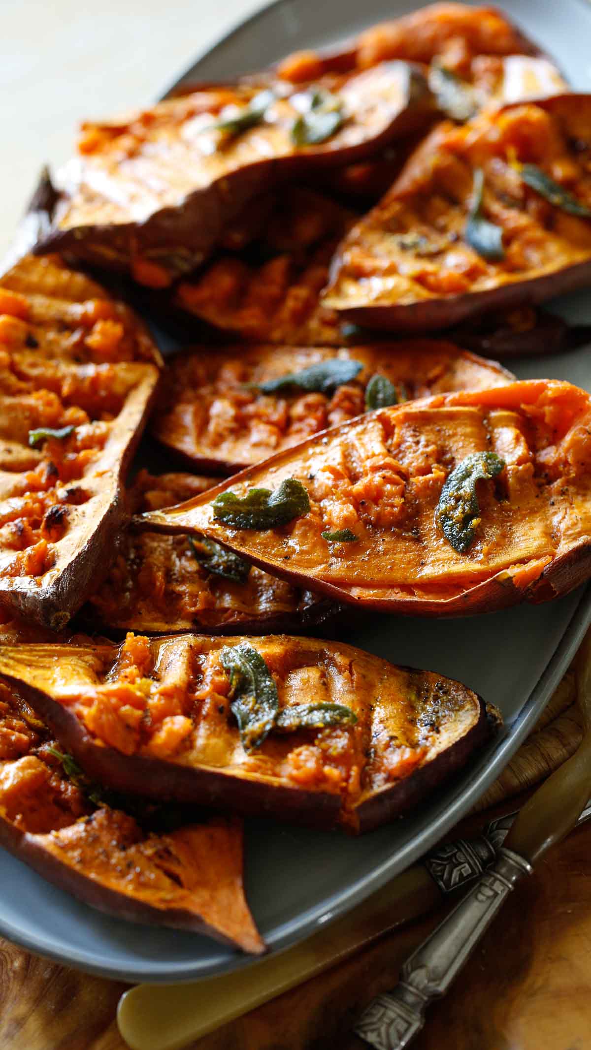 Sweet Potato halves that have been smashed and baked on a platter