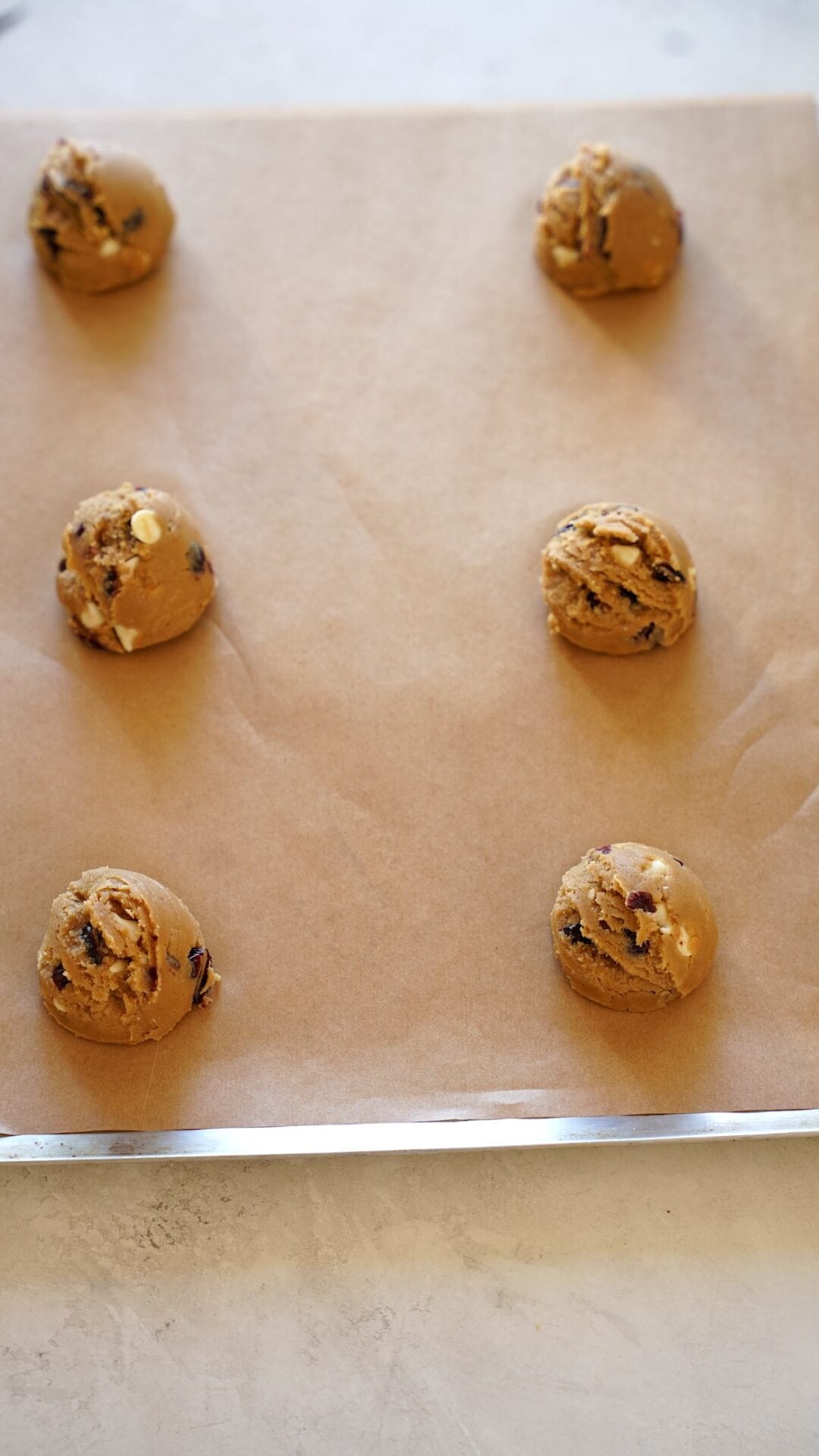 Cookie Dough balls on a cookie sheet lined with parchment paper