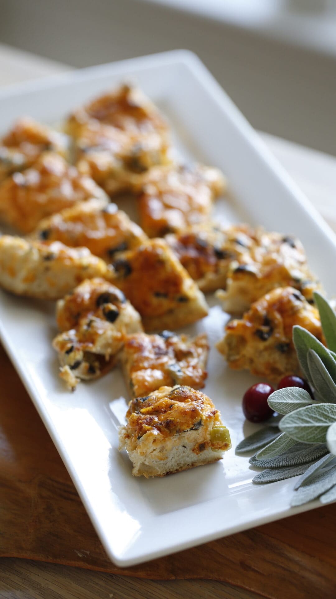 a platter of English muffin appetizers cut into quarters