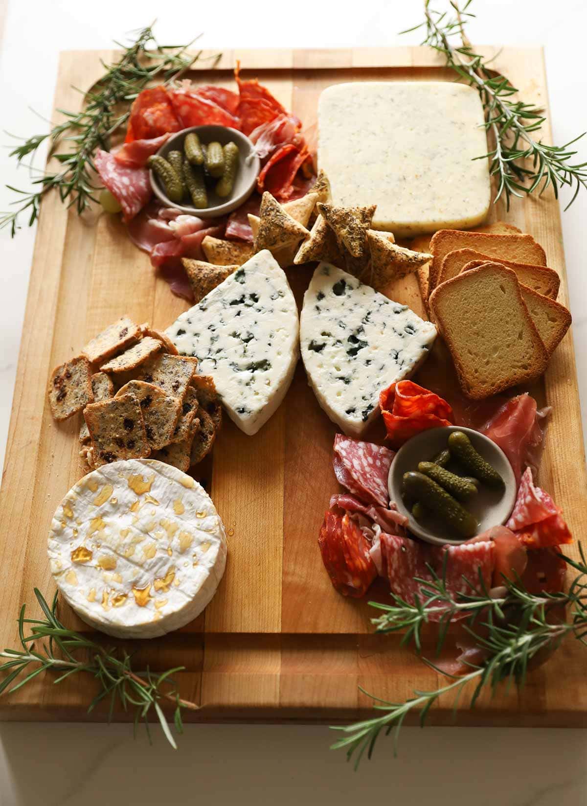 A board with cheese, crackers and charcuterie