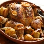 A platter of chicken roasted with potatoes.