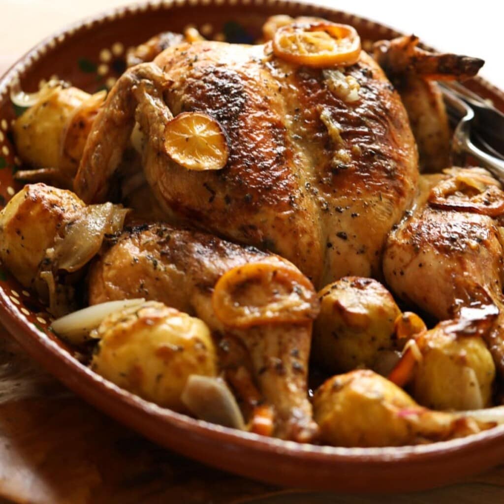 a platter of spatchcock chicken and potatoes.
