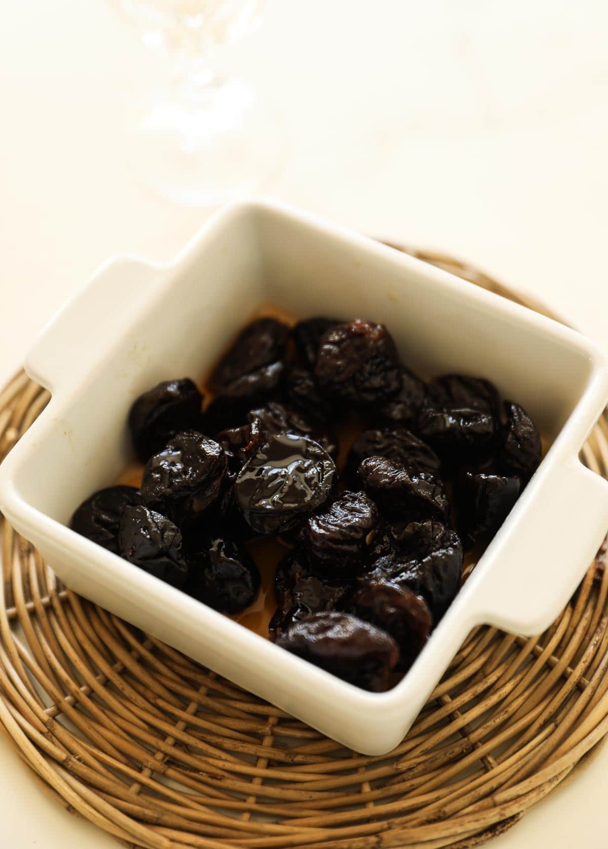 Prunes in a container soaked in rum.