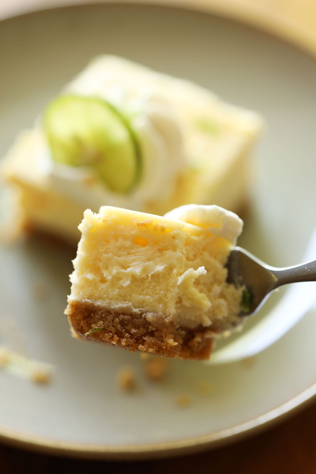 a bite of cheesecake on a fork to show the creamy texture.