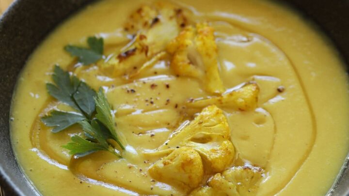 Roasted Cauliflower Soup in a black bowl