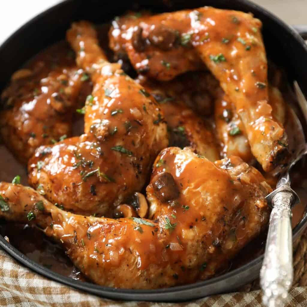 Chicken legs in a mushroom sauce arranged in a braiser