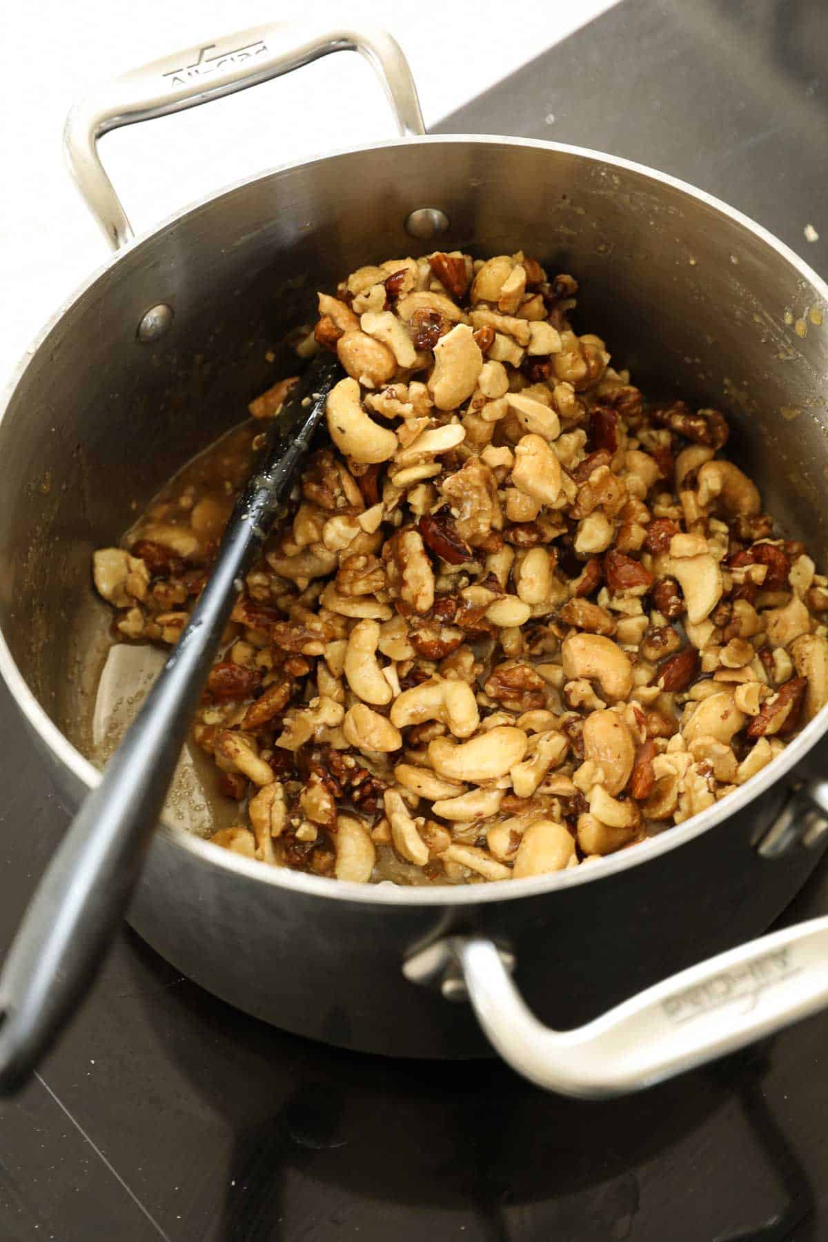 Nuts covered in sugar syrup in a pot