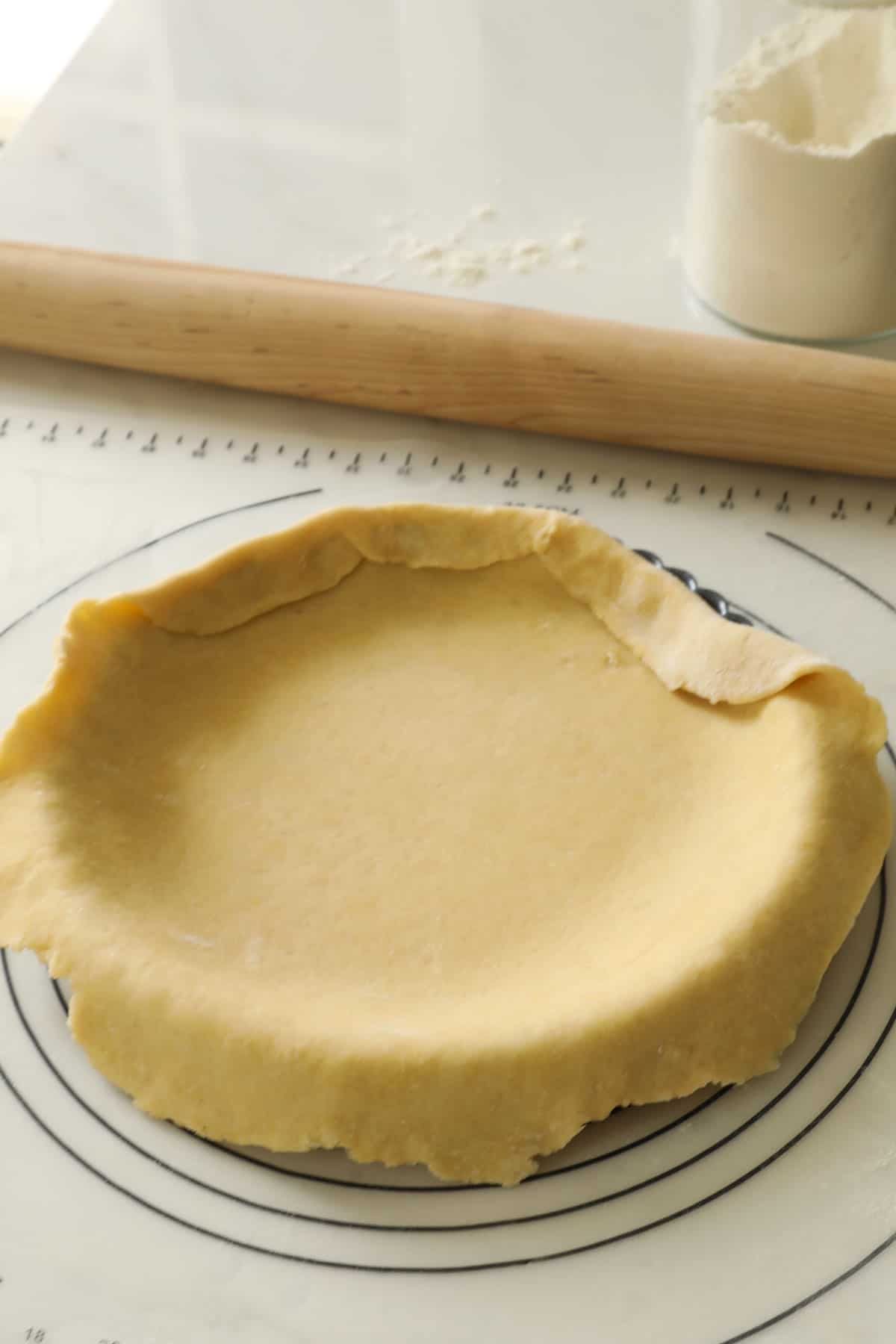 Tart dough draped over a tart tin