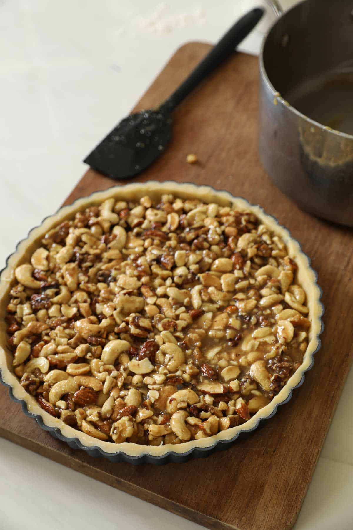 A tart shell filled with nuts in a sugar syrup