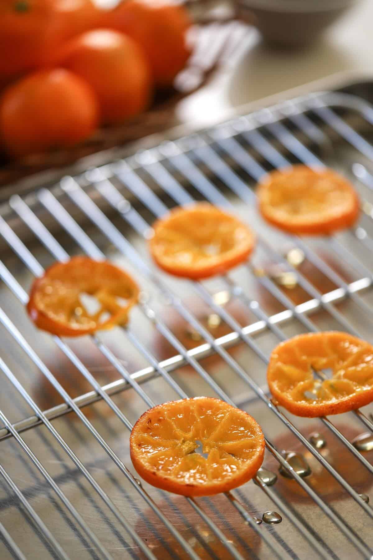 Candied Oranges drying on a cooling rack.