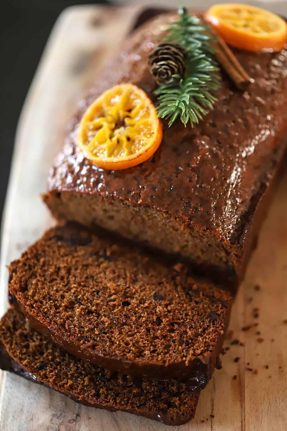 French spiced cake sliced on a cutting board.