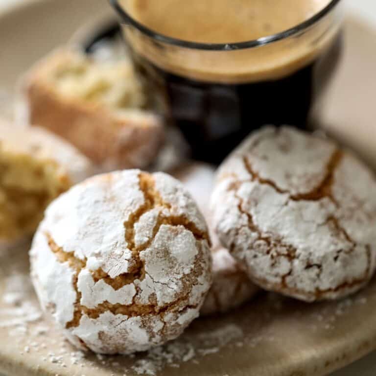 Cookies on a plate with a cup of espresso