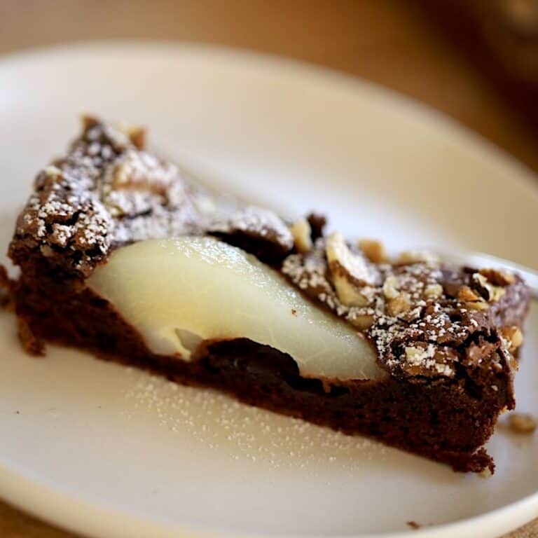 A slice of Chocolate Pear Tart on a Plate