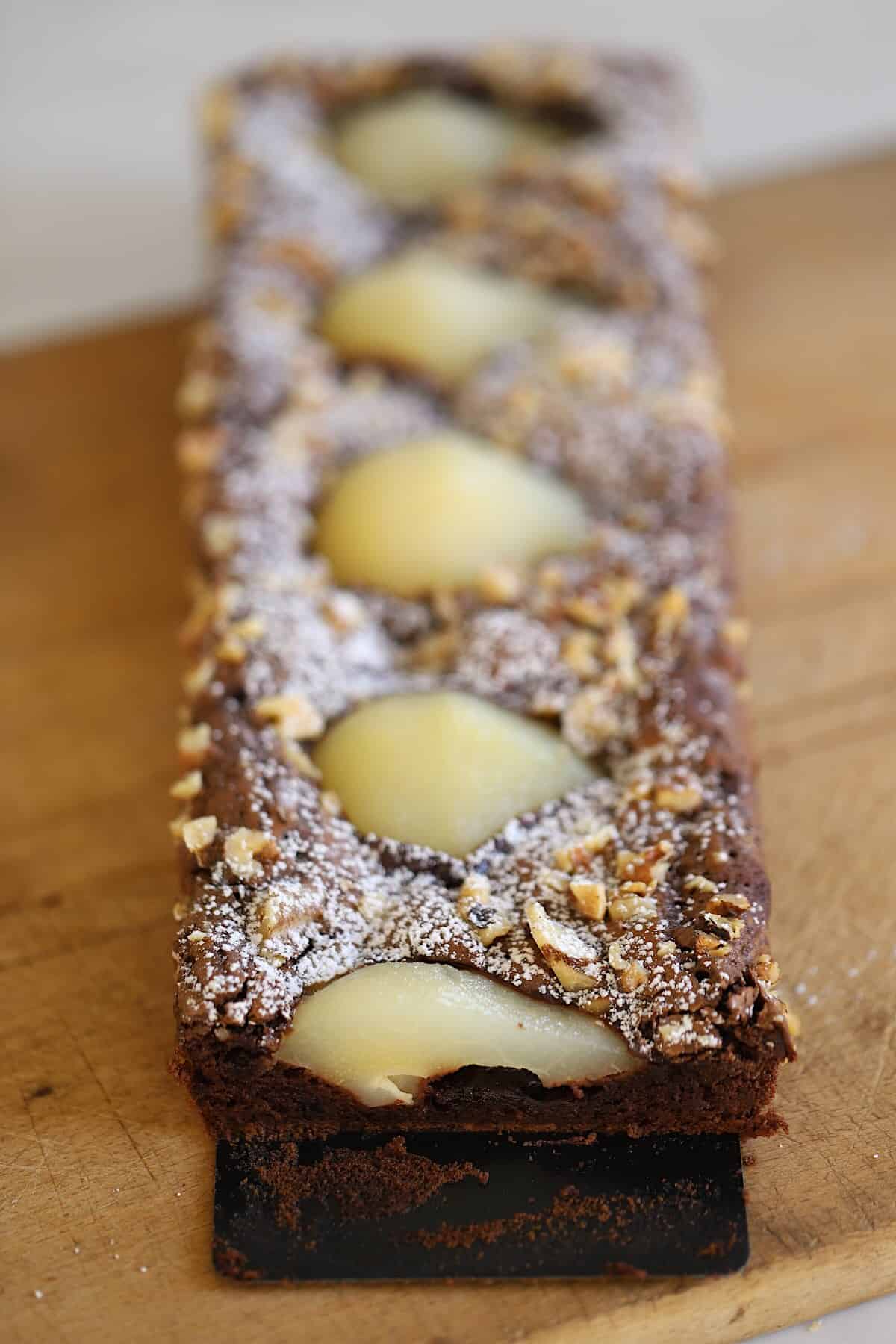 a baked Pear and Chocolate tart, sliced into revealing the pear interior.