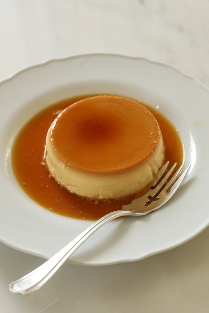 creme caramel on plate with a fork