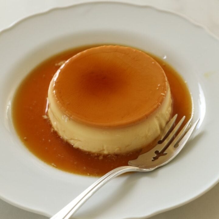 Creme Caramel on a white plate with a fork