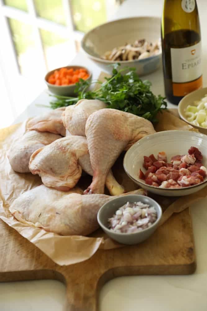 Ingredients for Coq au vin on a cutting board