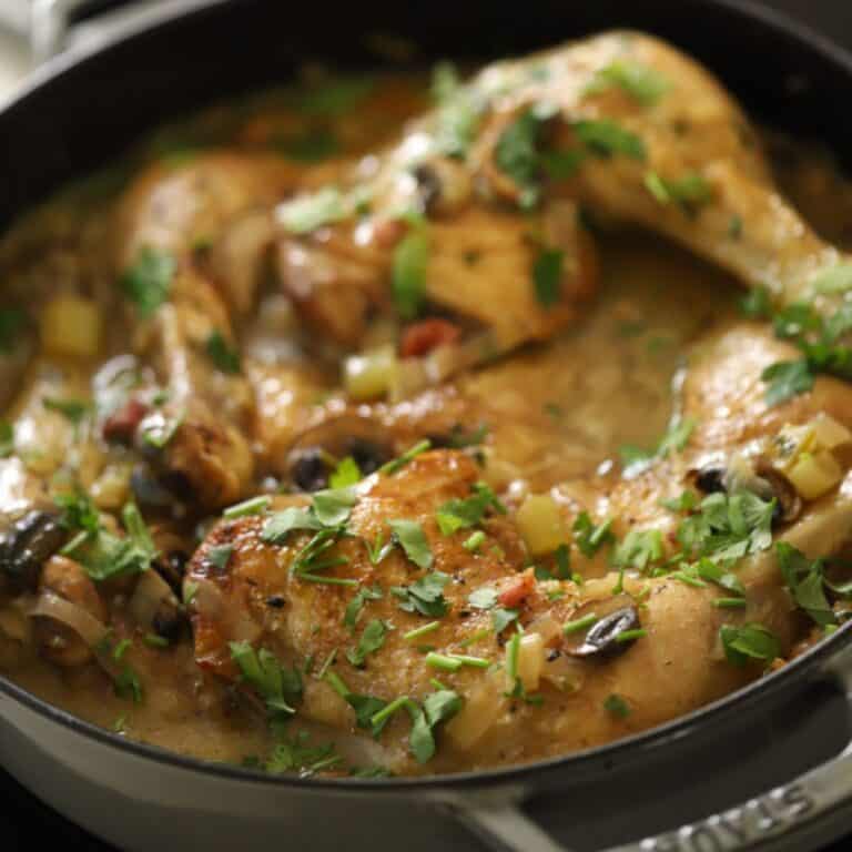 Coq au vin blanc in a gray braiser