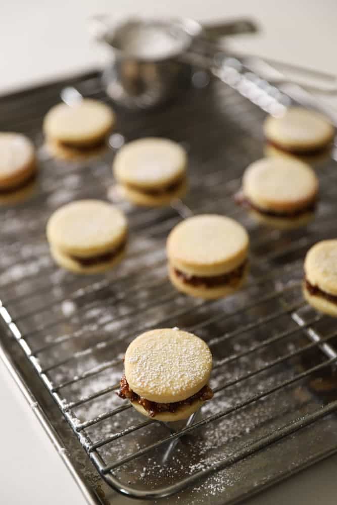 Sanwiched fig and walnut cookies dusted with powdered sugar.