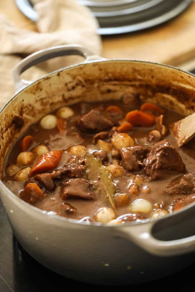 A Dutch Oven filled with beef bourguignon,