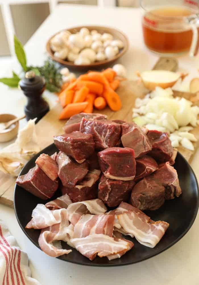 Beef, Bacon, Vegetables and spices laid out for a beef stew.