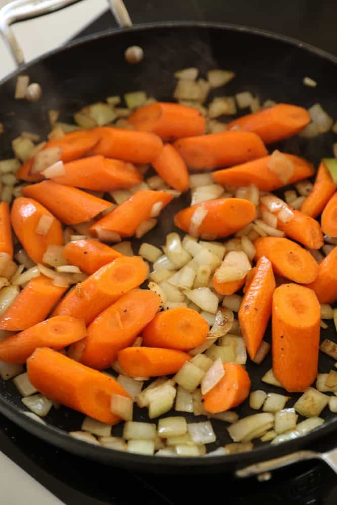carrots sautéing in bacon fat with onions