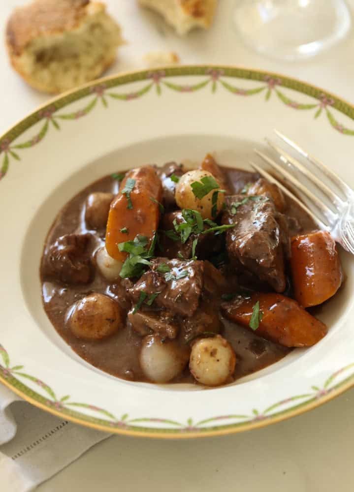 a bowl of beef bourguignon in a shallow bowl.