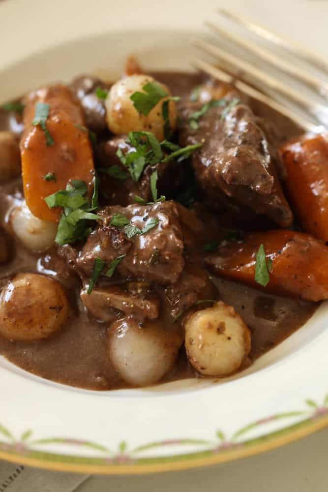 a close up of beef stew in a bowl.
