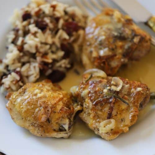 crispy chicken on a plate with sauce and wild rice