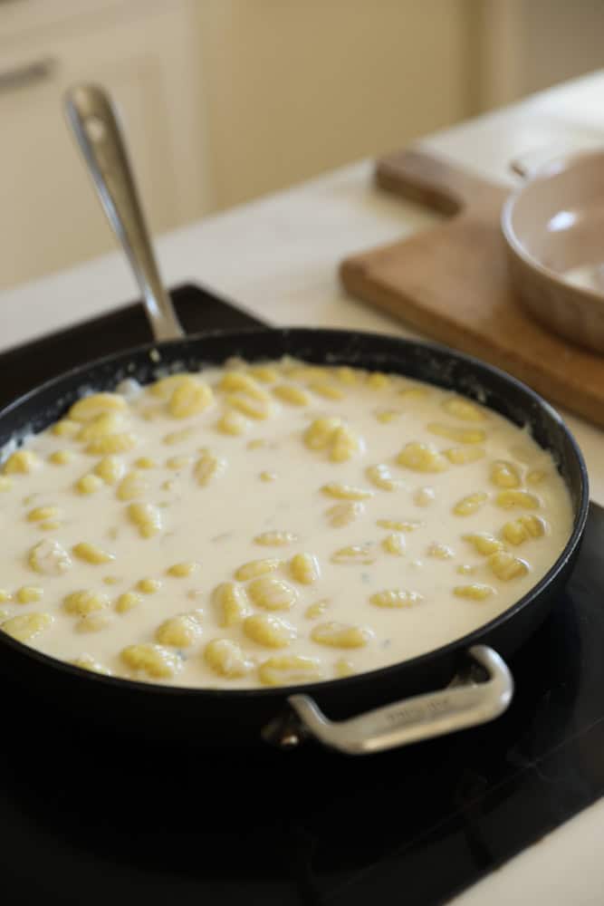 gnocchi tossed in a cream sauce in a large non-stick skillet.