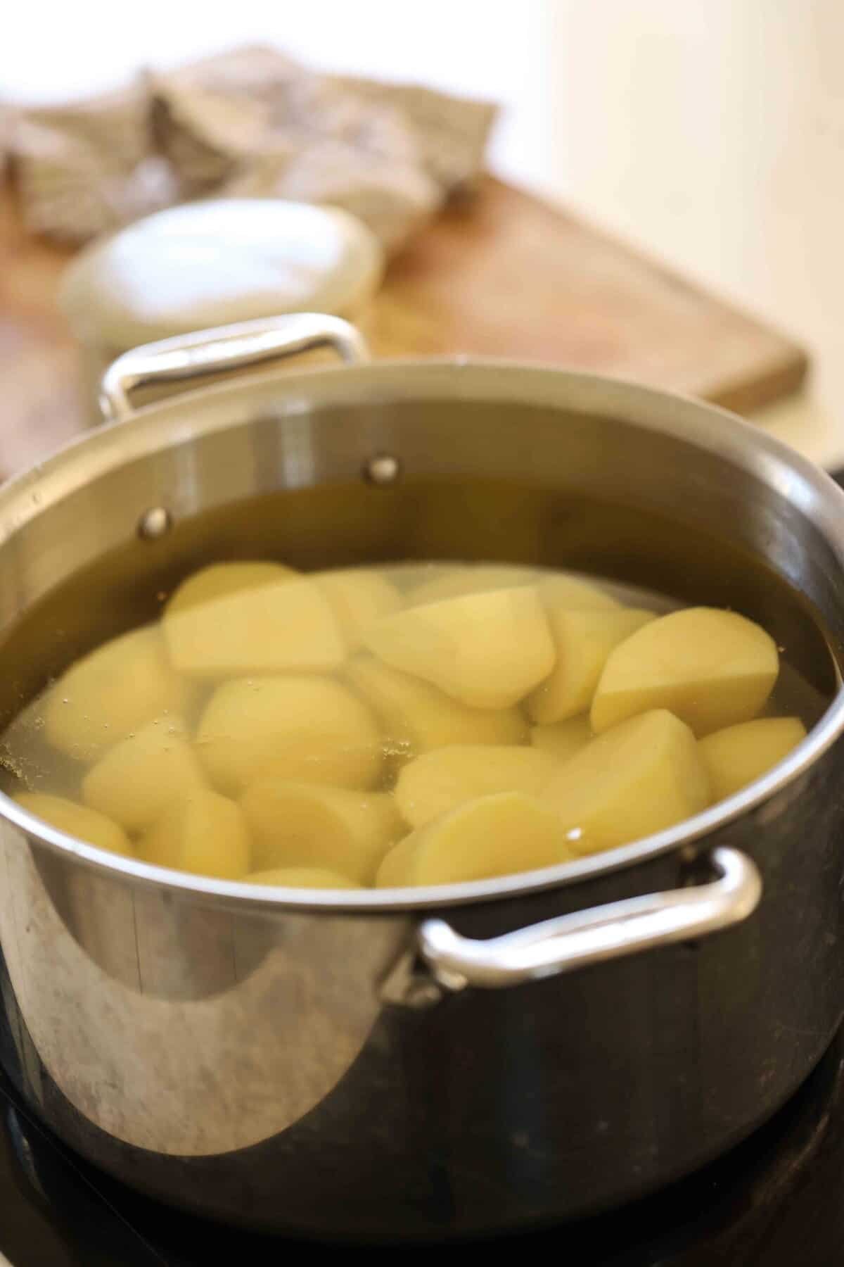 Potatoes in a large pot covered with water and set to boil.