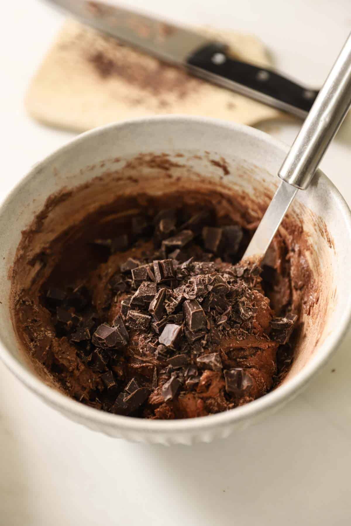 Chocolate chunks added to the egg and chocolate mixture.