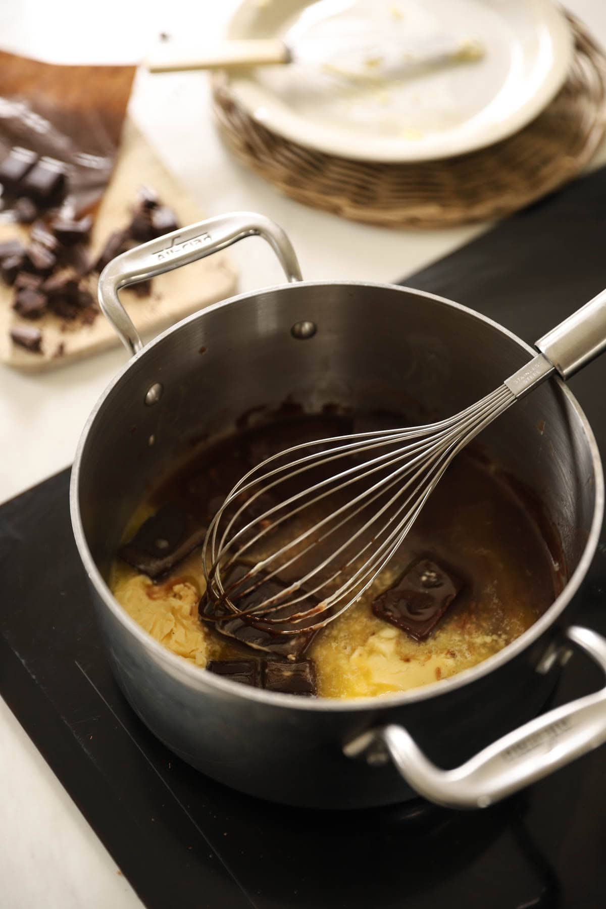 Butter and bittersweet chocolate melting in a pot.